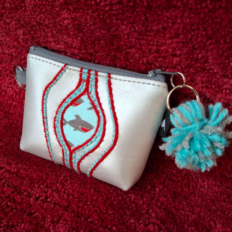 Sacred Fruit Silver Embroidered Vagina Vulva Wallet with Shark Print Sweet Spot. Made by Anne Marie Beard. Handmade in Austin, Texas since 2002 y'all! annemarie yoni feminist divine feminine shark week shark bite jaws