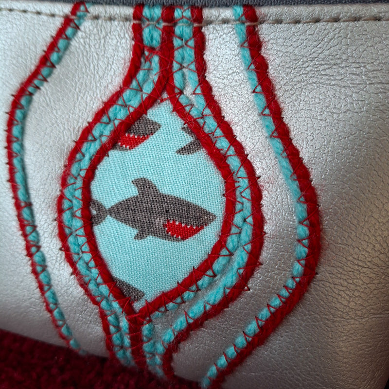 Sacred Fruit Silver Embroidered Vagina Vulva Wallet with Shark Print Sweet Spot. Made by Anne Marie Beard. Handmade in Austin, Texas since 2002 y'all! annemarie yoni feminist divine feminine shark week shark bite jaws