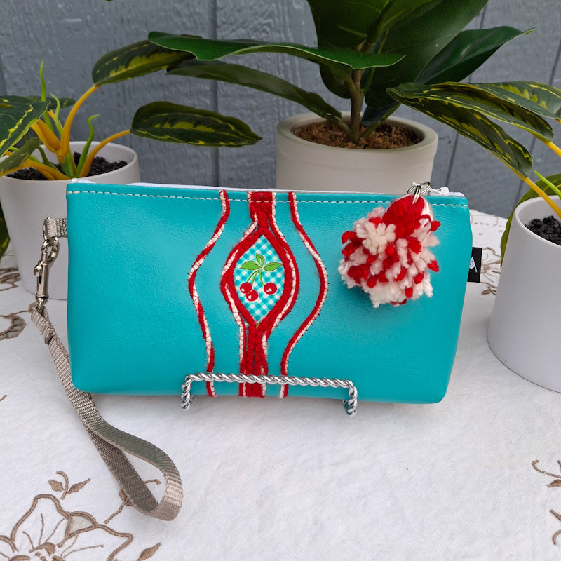 Sacred Fruit Teal Embroidered Vagina Vulva Wallet with Cherry Sweet Spot. Made by Anne Marie Beard. Handmade in Austin, Texas since 2002 y'all! annemarie yoni feminist divine feminine cherry picnic