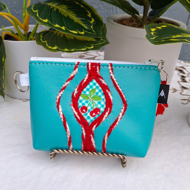 Sacred Fruit Teal Embroidered Vagina Vulva Wallet with Cherry Sweet Spot. Made by Anne Marie Beard. Handmade in Austin, Texas since 2002 y'all! annemarie yoni feminist divine feminine cherry picnic